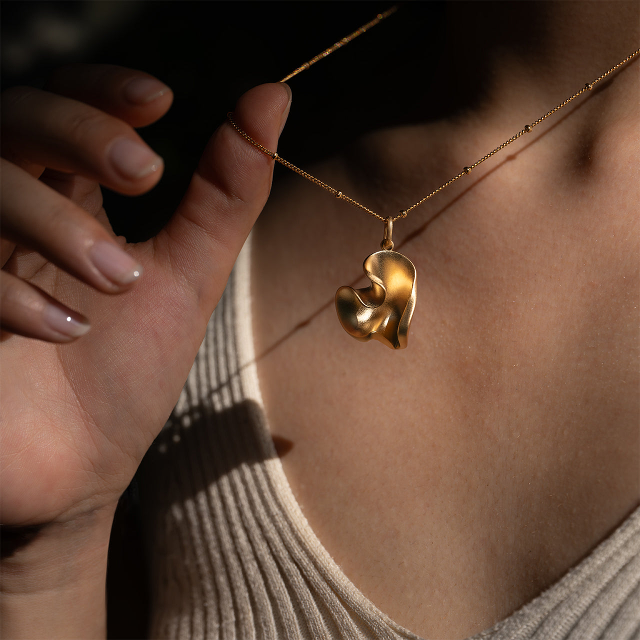 LOVE gold heart-shaped pendant-on model